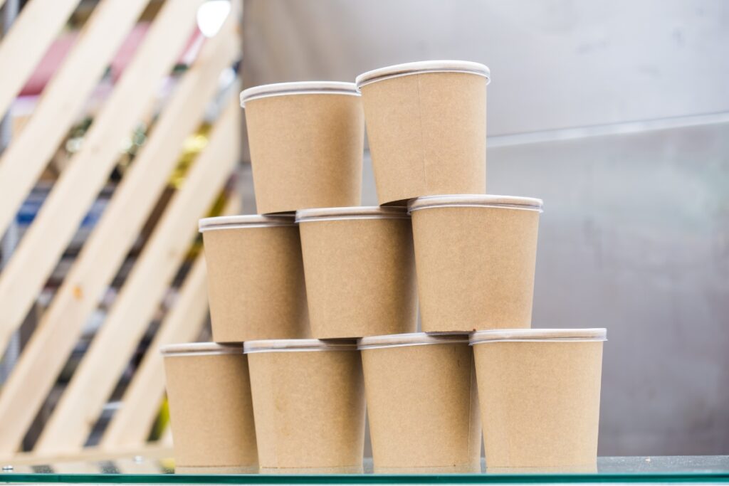 Nine stacked Dogfish Packaging takeout containers.